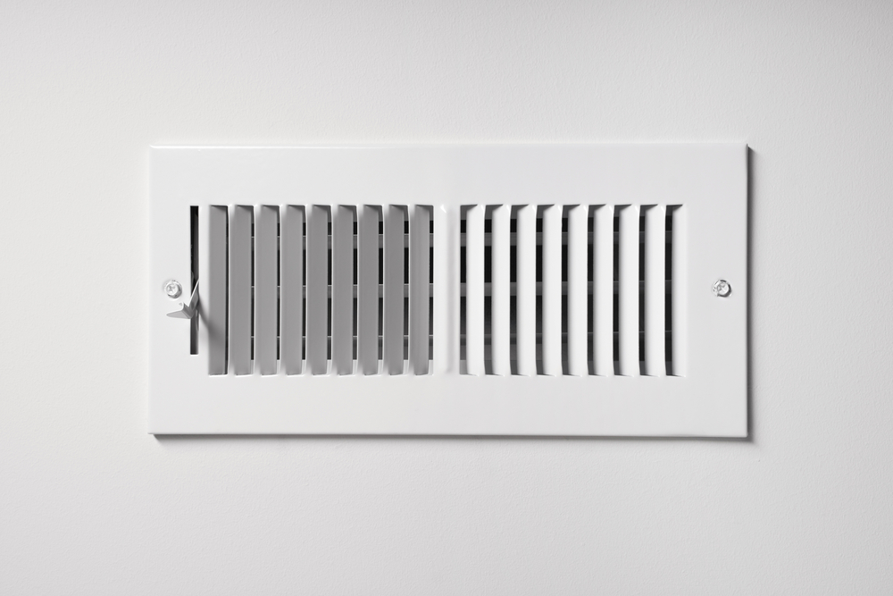 White heating vent on white wall of a home