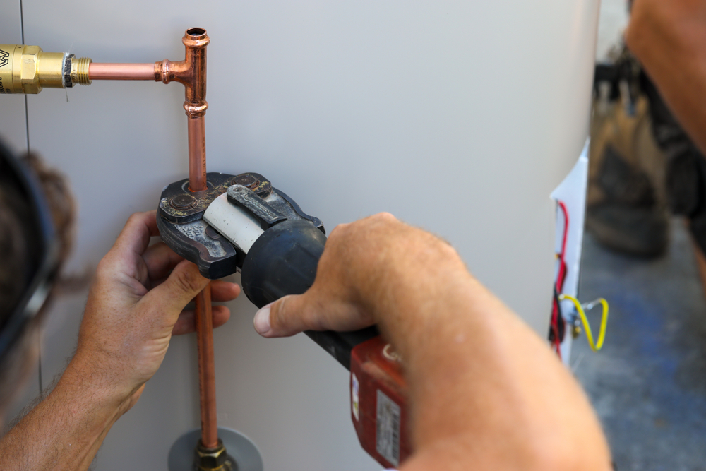 Close up of a plumber working on a hot water system