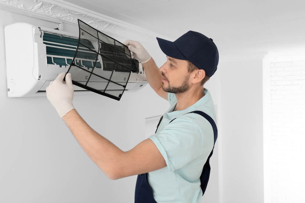 AC technician working on a split system indoor unit