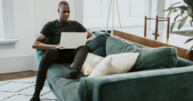 Gas-ducted-and-reverse-cycle-heating-Man-on-couch-with-laptop-in-a-good-heating-environment