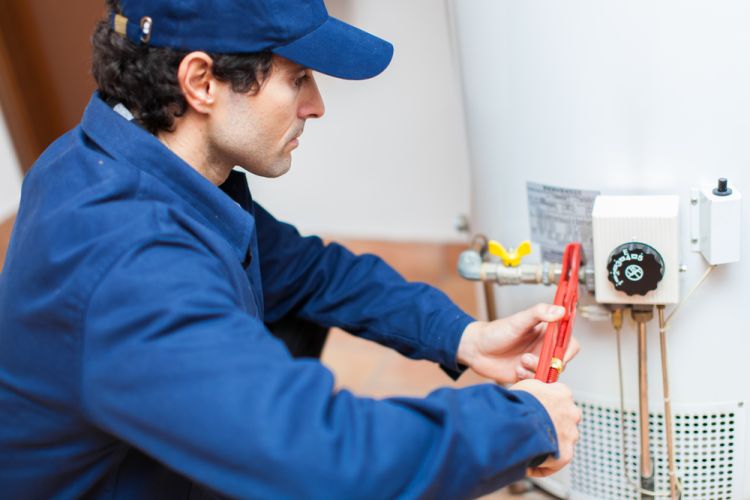 Technician installing hot water unit