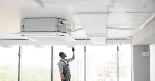 Technician installing Ducted Reverse Cycle Daikin Unit