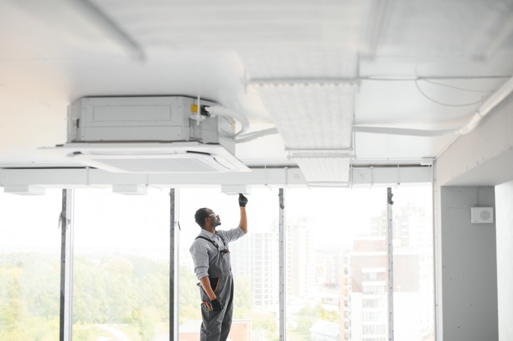 Technician installing Ducted Reverse Cycle Daikin Unit